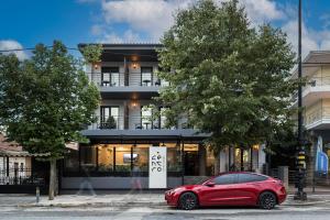a red car parked in front of a building at Centro Urban Stay in Ioannina