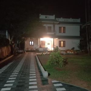 a house at night with a lit up driveway at Keralan Homestay in Alleppey