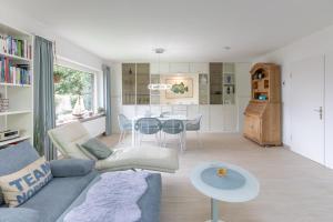 ein Wohnzimmer mit einem Sofa und einem Tisch in der Unterkunft Noordhuus in Nordstrand