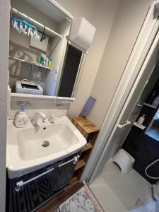 a bathroom with a sink and a mirror at Meguro-ku - House - Vacation STAY 8878 in Tokyo
