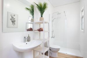 a bathroom with a white sink and a toilet at EDEN RENTALS B01 Surfy Stylish Bed&Coffee Room in Granadilla de Abona