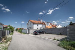 a car parked on the side of a street at Apartments by Pyramid: Christoph in Bratislava