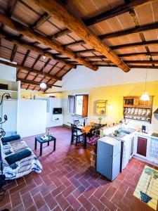 a large room with a kitchen and a living room at La casa nella vigna [colline del vino] in Capannori