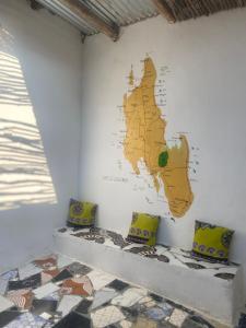 a mural of a map on a wall in a room at Malaika House Paje in Paje