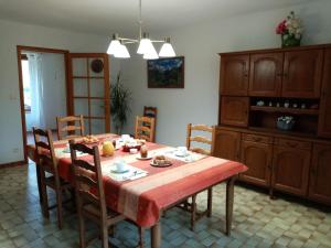 a dining room table with a red table cloth on it at Chambres d'Hôtes d' En Jouti in Avignonet-de-Lauragais