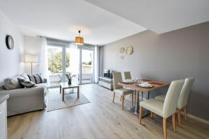 a living room with a table and a couch at OVELIA Toulouse - Les Bastides de Lardenne in Toulouse
