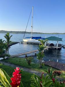 a sailboat is docked at a dock on the water at Akwaba Lodge in The Gap