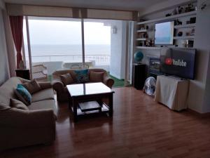 a living room with a couch and a tv at De la Montaña al Mar in Almería