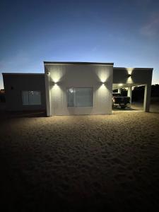 a house with lights on the side of it at Casa barrio cerrado Las Lomas in Monte Hermoso