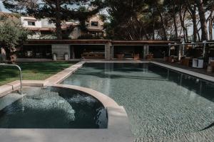 a swimming pool in the yard of a house at Praia Art Resort - Small Luxury Hotels of the world in Le Castella