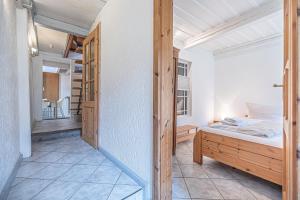 a small bedroom with a bed and a hallway at fewo1846 - Altes Steuermannhaus - uriges Reihenhaus mit 2 Schlafzimmern in der Altstadt in Flensburg