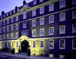a large brick building with a yellow light on it at Gem Fitzrovia Hotel in London