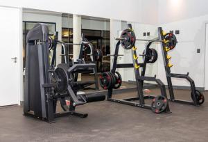 a gym with several tread machines in a room at Apartments at Brooklyn/Waterkloof in Pretoria