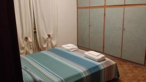 a bedroom with a bed with two towels on it at Casa Farinati 2 in Verona