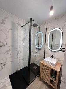 a bathroom with a shower and a sink and mirrors at 7mn de Deauville Jardin Wifi Box TV in Saint-Arnoult