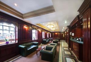 a waiting room with couches and chairs in a building at Gem Fitzrovia Hotel in London