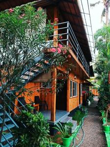 a building with a staircase and some plants at The Lake Paradise Boutique Resort in Alleppey