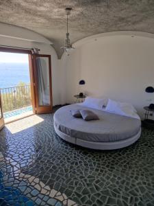 a bedroom with a bed with a view of the ocean at HOLIDAY double in Praiano