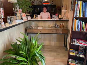 a woman behind the counter of a book store at Hotel Nordlicht in Schwerin