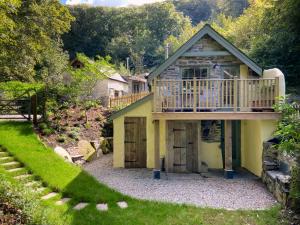 a house with a deck and a balcony at The Barley Mill in Bude