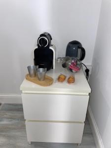 eine weiße Kommode mit Tassen drauf in der Unterkunft Chambre moderne proche Monaco G in Beausoleil