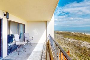 a balcony with chairs and a view of the beach at Surf Dweller 203 in Fort Walton Beach