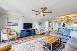 a living room with a couch and a tv at Surf Dweller 203 in Fort Walton Beach