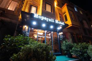 a sign on the front of a restaurant at night at HOPEFULL HOTEL in Istanbul