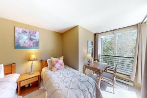 a bedroom with a bed and a desk and a window at Simba Run, Unit 1510 in Vail