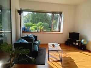 a living room with a couch and a window at Ferienwohnung Haus Knäppen Size S in Oelde