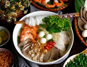 a bowl of food with shrimp and other foods at Thiên Tài Hotel in Ho Chi Minh City