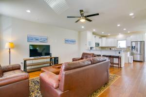 a living room with two couches and a kitchen at Luxury Ocean City Retreat with Beautiful Bay Views in Ocean City