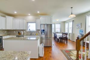 a kitchen with a refrigerator and a dining room at Luxury Ocean City Retreat with Beautiful Bay Views in Ocean City