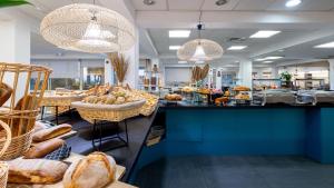 a bakery with lots of loaves of bread on display at Village Club L'Oustal Del Mar in Le Lavandou