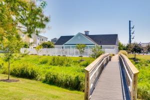 a wooden bridge in a park with a house at Luxury Ocean City Retreat with Beautiful Bay Views in Ocean City