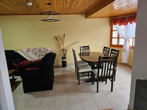 a living room with a table and chairs and a couch at La Herradura de Ushuaia in Ushuaia