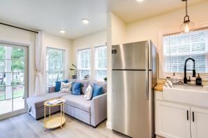 a kitchen with a couch and a refrigerator at Cozy Cottage Minutes to Downtown Southport! in Southport