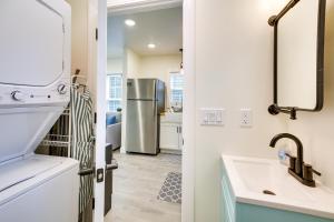a kitchen with a sink and a refrigerator at Cozy Cottage Minutes to Downtown Southport! in Southport +18 photos