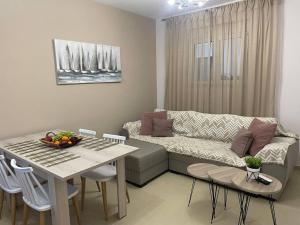 a living room with a couch and a table at Anastasia’s Home in Chania