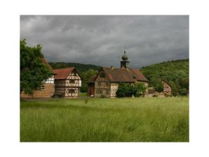 an old house in the middle of a field at Stadthaus in Mellrichstadt