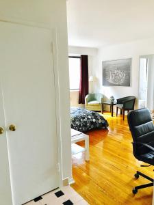 a living room with a couch and a chair at Stylish Montreal Apartment: Comfortable Stay in the Golden Square Mile in Montreal