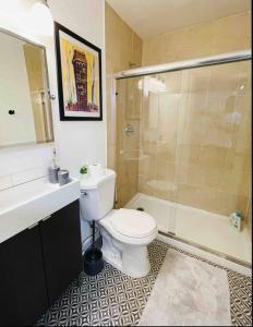 a bathroom with a toilet and a sink and a shower at Artist's retreat near the heart of the city in Sacramento