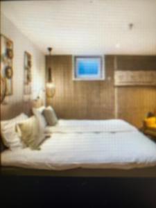 a bedroom with a large white bed in it at Domburg Holiday Resort in Domburg