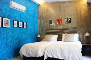 Ένα ή περισσότερα κρεβάτια σε δωμάτιο στο The Owl Homestay