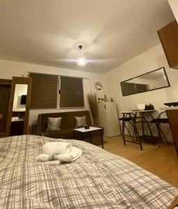 a bedroom with a large bed with a white towel on it at Apartman Fany in Sarajevo