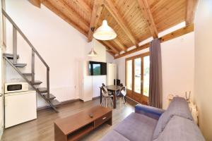 ein Wohnzimmer mit einem Sofa und einem Tisch in der Unterkunft Encantador ático estudio delante GrandValira HUT 5163 in El Tarter