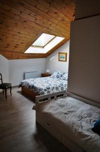 a bedroom with two beds and a skylight at La lanterne in Gap