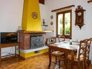 a dining room with a table and a fireplace at Holiday Home La Casina by Interhome in Olivone +28 photos