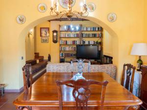 a living room with a wooden table and a couch at Villa Farfa by Interhome in Mompeo