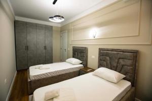 a room with two beds and a mirror at Luxury Apartment at Condor Center in Tirana